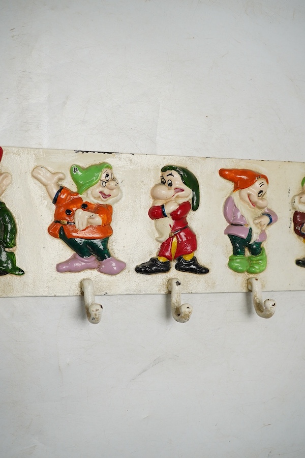 A 'Seven dwarfs' painted cast iron coat rack, 58cm wide. Condition - fair, some chipping